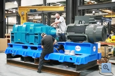 Two engineers working on a motor
